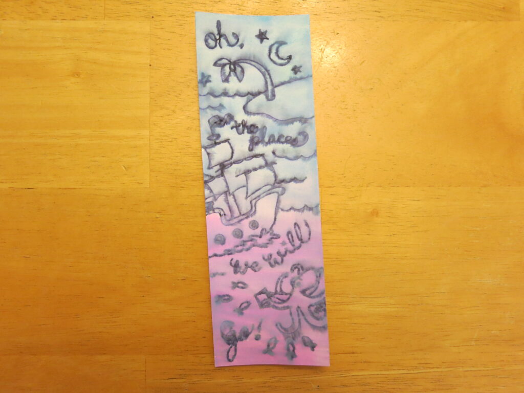 The nautical bookmark painted with a pink to blue gradient. 